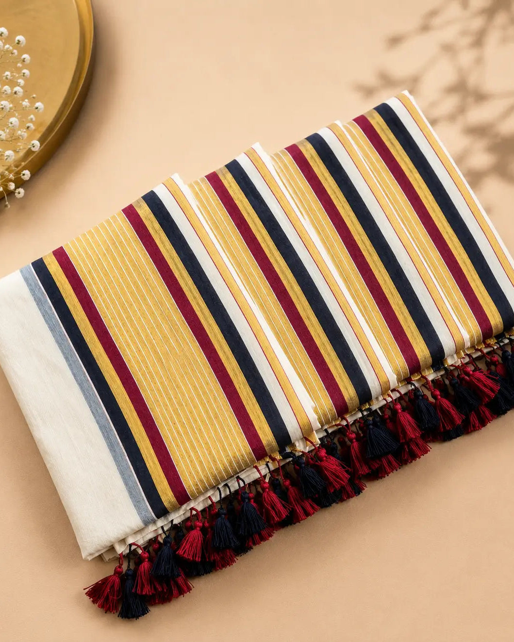 Striped fabric with tassels on a beige background